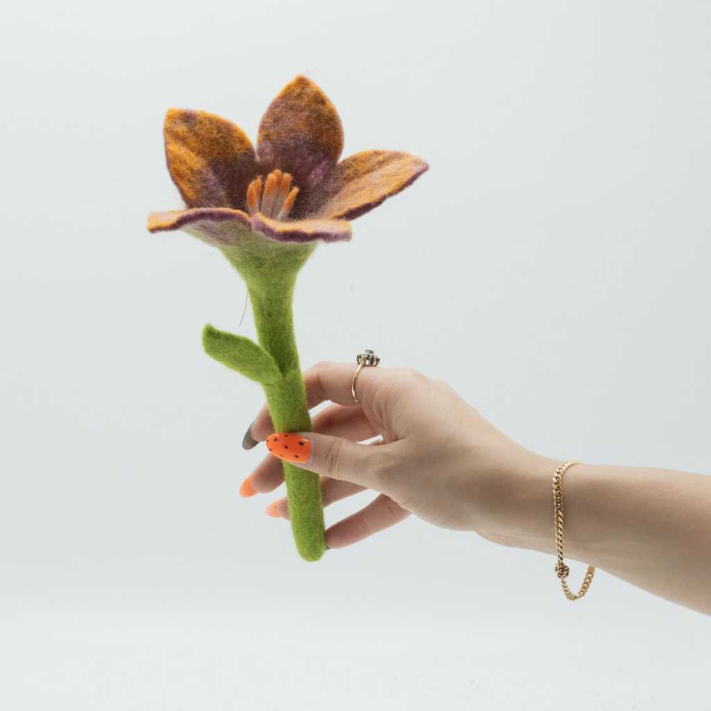 a lily being held in a hand